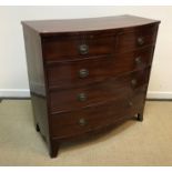 A 19th Century mahogany bow fronted chest of two short over three long graduated drawers with urn