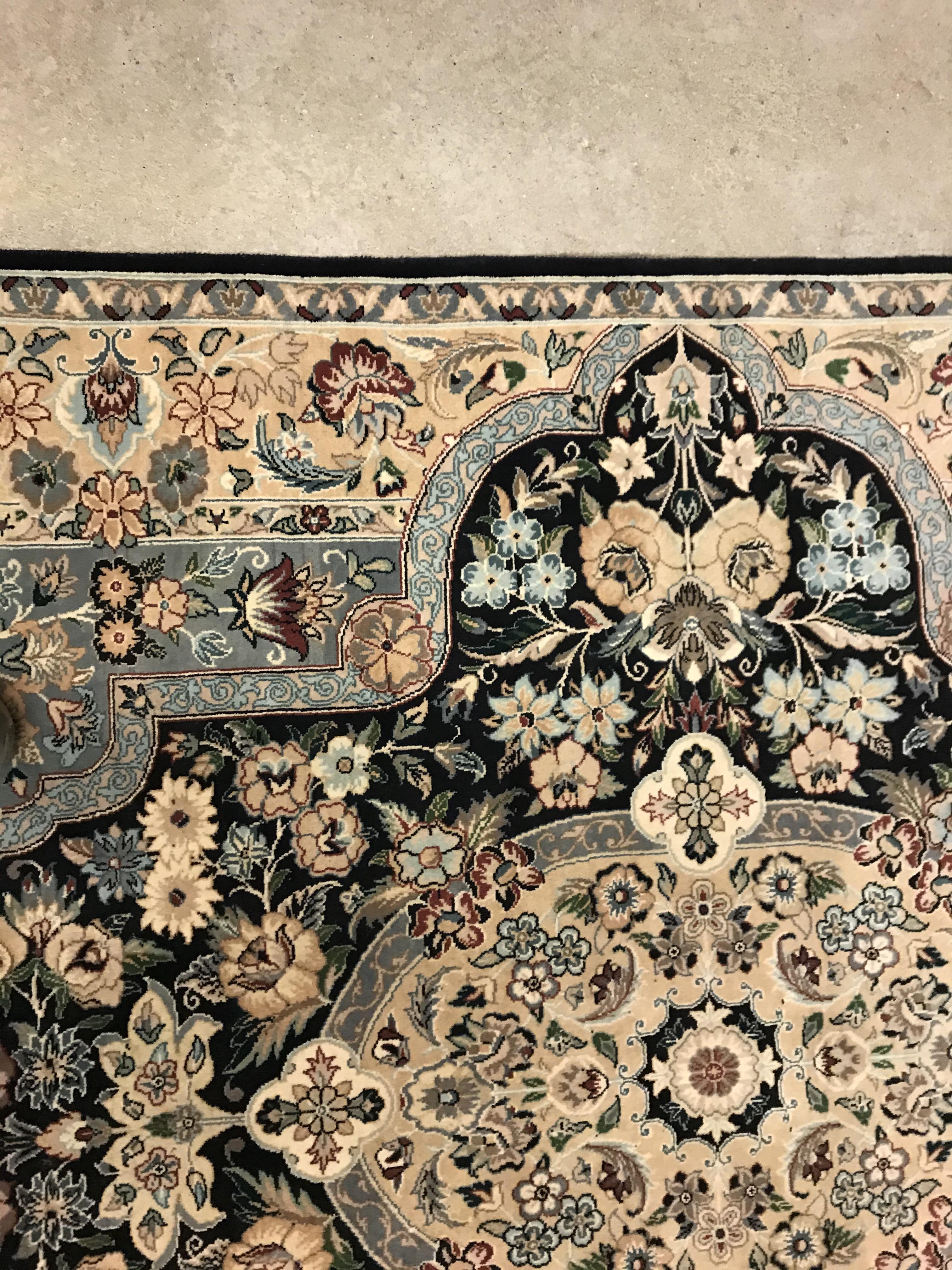 A Persian rug, the central panel set with floral decorated oval medallion on a dark blue and pale - Image 5 of 10