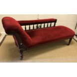 A Victorian mahogany framed chaise longue, the buttoned scroll end and railed back over an