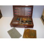 A mahogany cased games compendium containing various games pieces including Chess, Draughts,