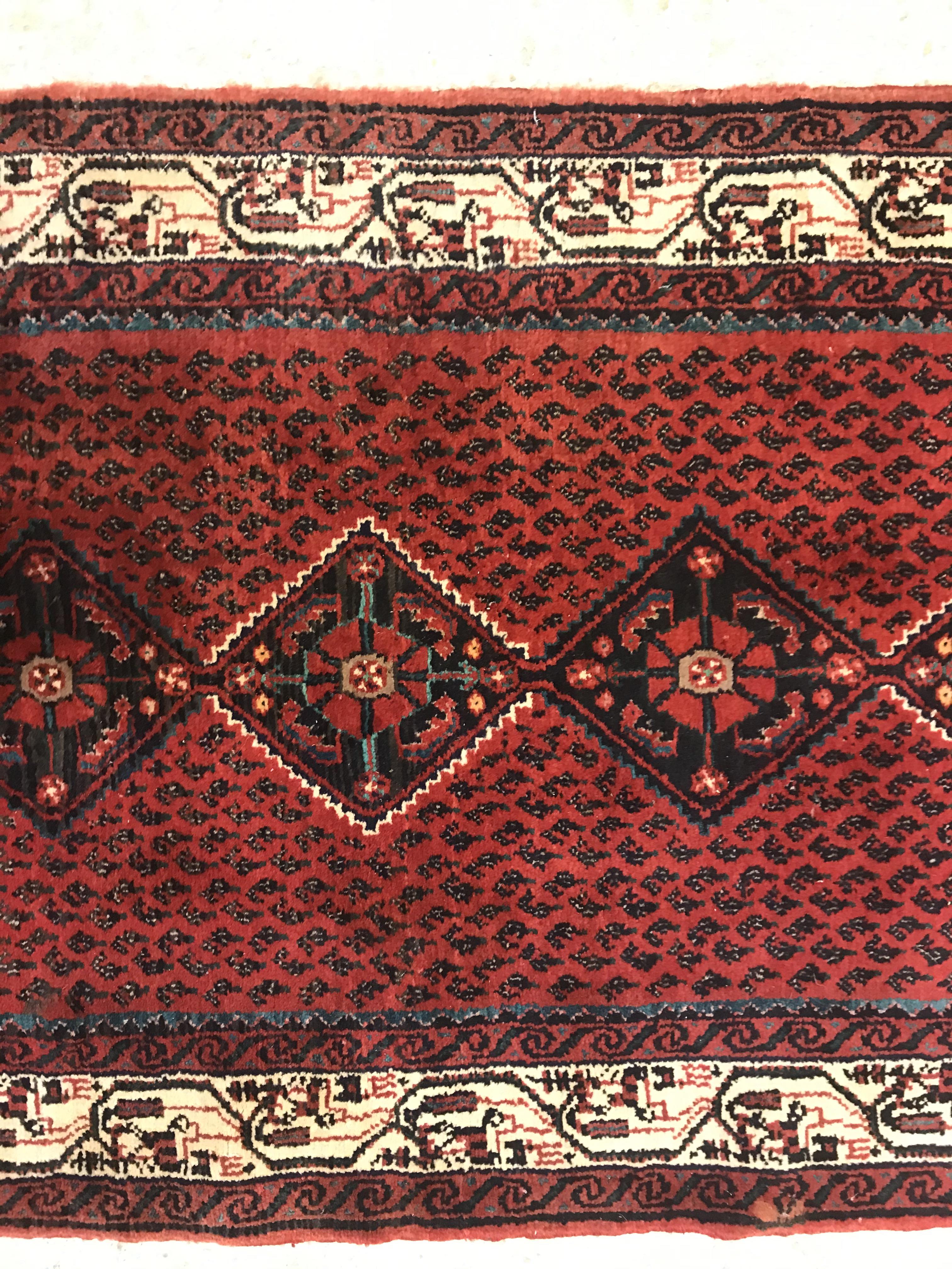 A modern Persian (Iran) runner, the red ground with repeating lozenge medallion with hook style - Image 10 of 23