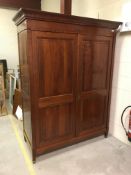 A modern French cherry wood wardrobe in the Louis Philippe taste, the moulded cornice over a