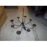 A 20th Century wrought iron eight branch chandelier, 79 cm diameter x 65 cm drop