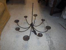 A 20th Century wrought iron eight branch chandelier, 79 cm diameter x 65 cm drop