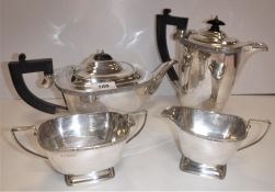 A George VI silver four piece tea set with Gothic style banded decoration, raised on a rectangular