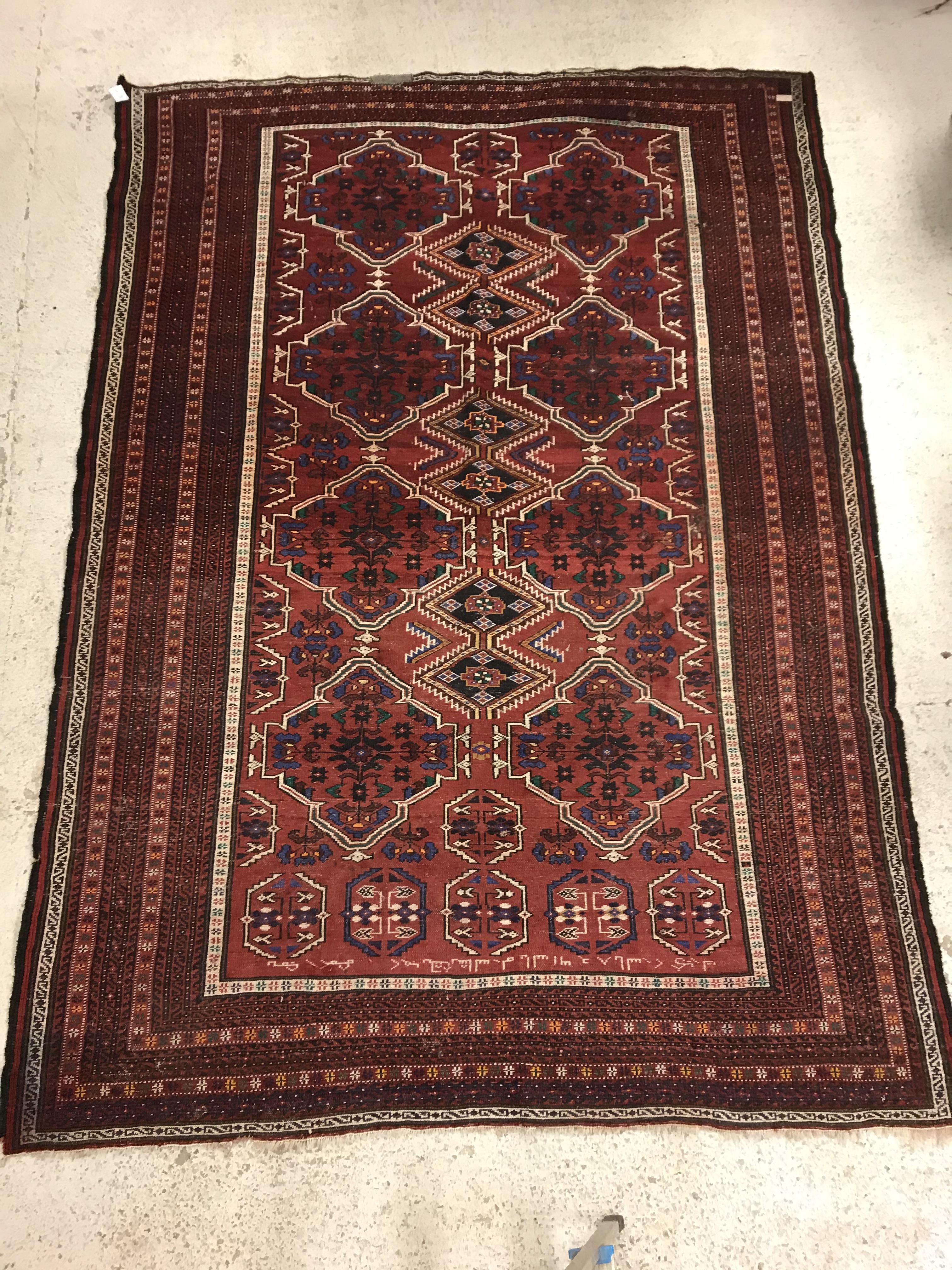 A Caucasian carpet, the central panel set with repeating medallion decoration on a blood red - Image 13 of 15