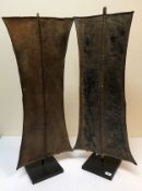 Two Kenyan Turkana shields in patinated metal, one with metal handle, the other with wooden and hide