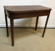 An early 19th Century mahogany and inlaid fold-over tea table on square tapered legs, 95.5 cm wide x