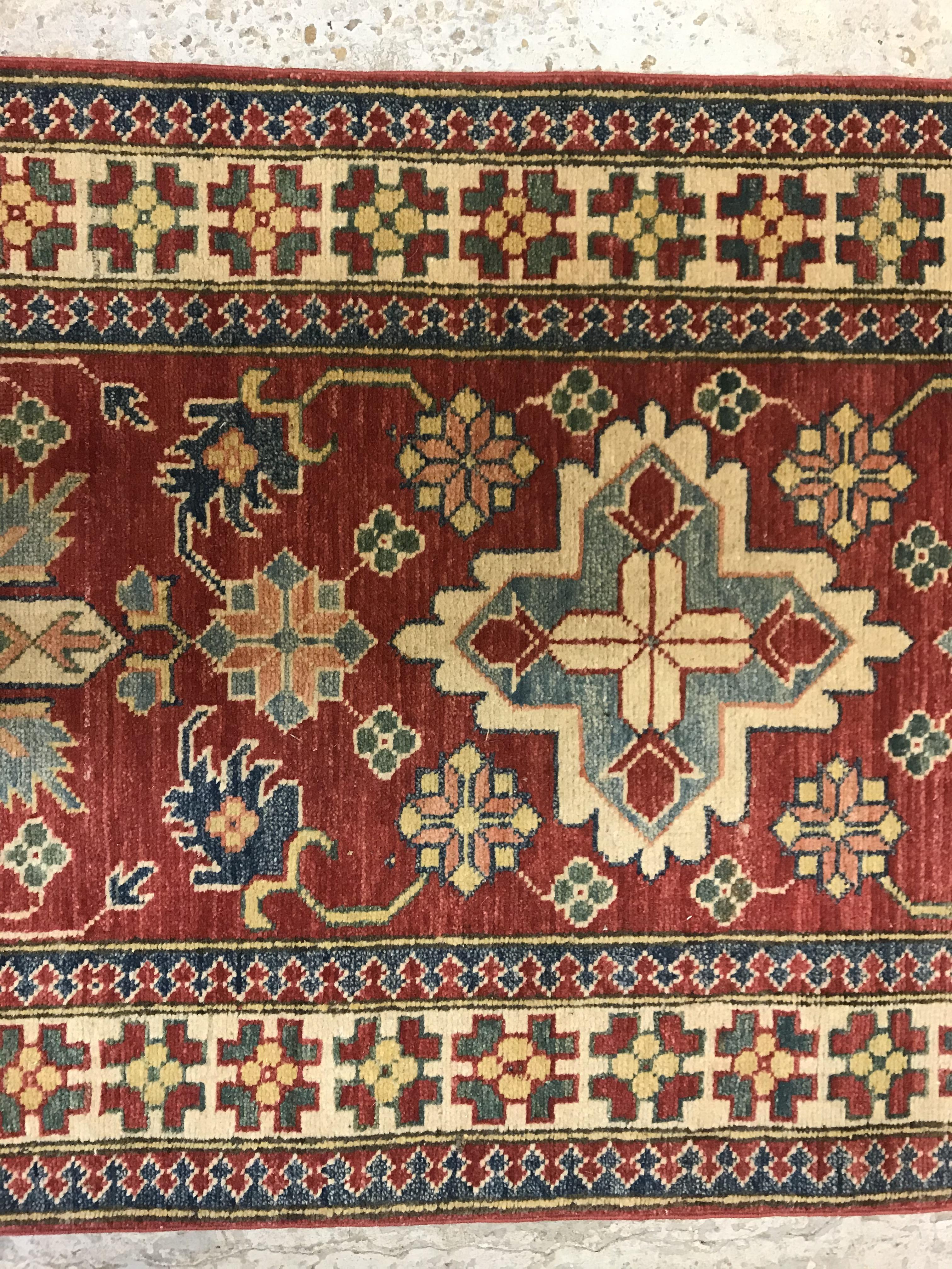 A modern Persian runner, the central panel set with repeating medallions on a red floral decorated - Image 5 of 13