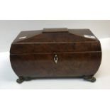 A 19th Century burr yew tea caddy of sarcophagus form, the top opening to reveal a central mixing