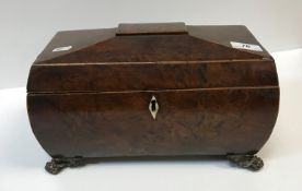 A 19th Century burr yew tea caddy of sarcophagus form, the top opening to reveal a central mixing