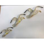 A set of three Beswick Gull wall ornaments (658-1,2 and 4), largest 36 cm long, smallest 20.5 cm