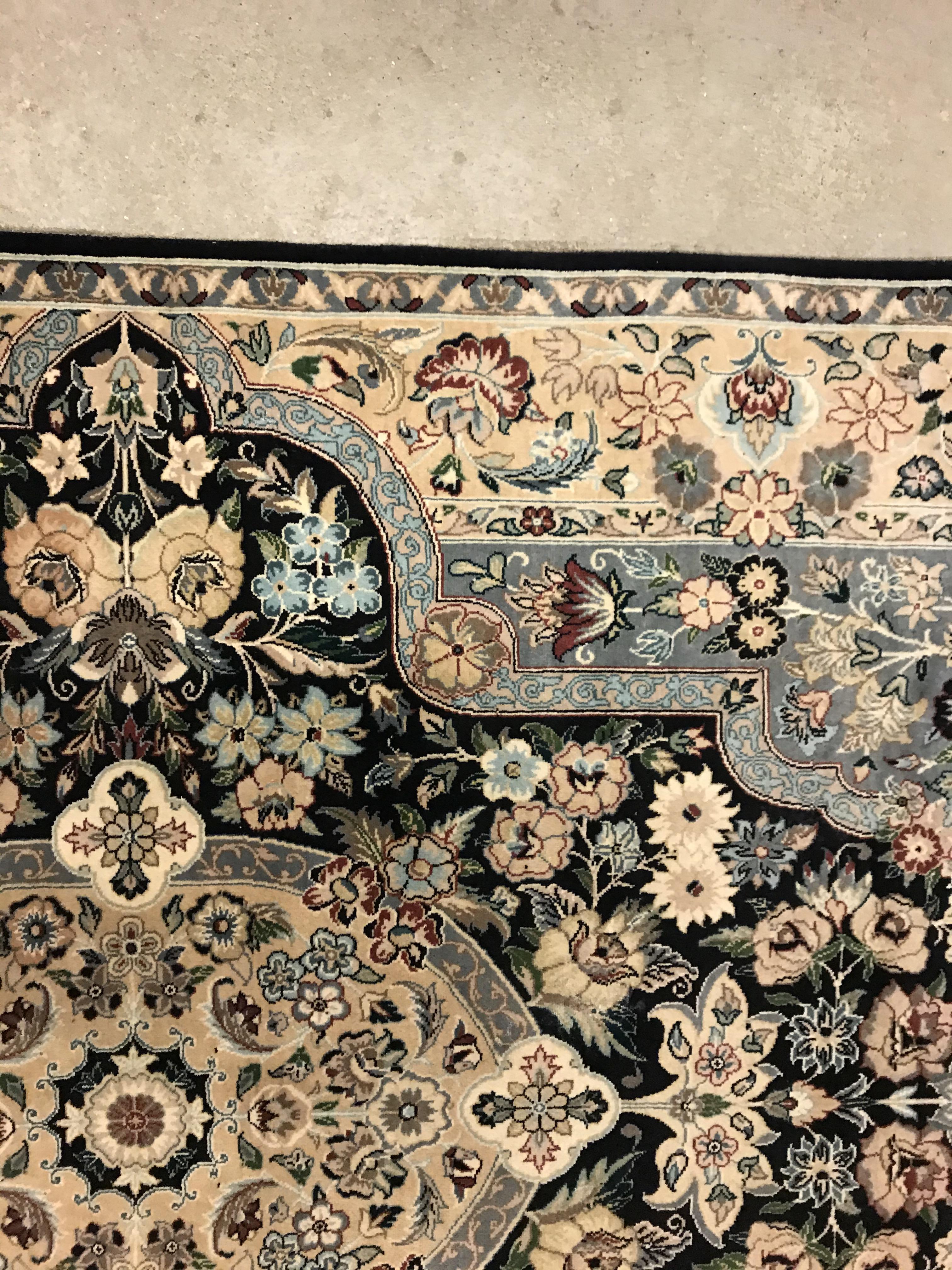 A Persian rug, the central panel set with floral decorated oval medallion on a dark blue and pale - Image 6 of 10
