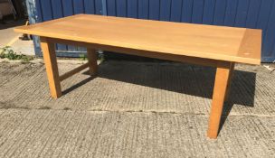 A modern Conran oak dining table, the plain top with cleated effect ends, raised on square supports,