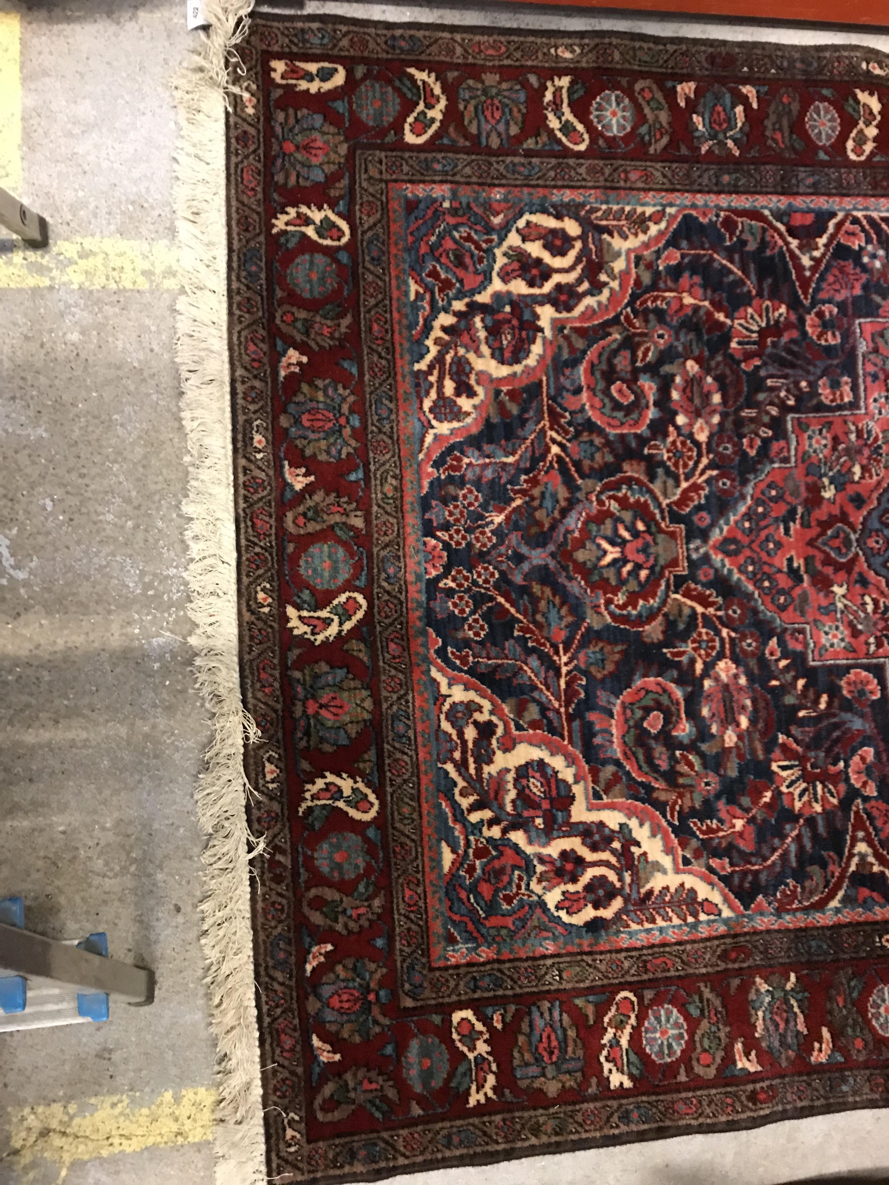 An Oriental carpet, the central panel set with foliate decorated medallion on a red and blue - Image 2 of 11