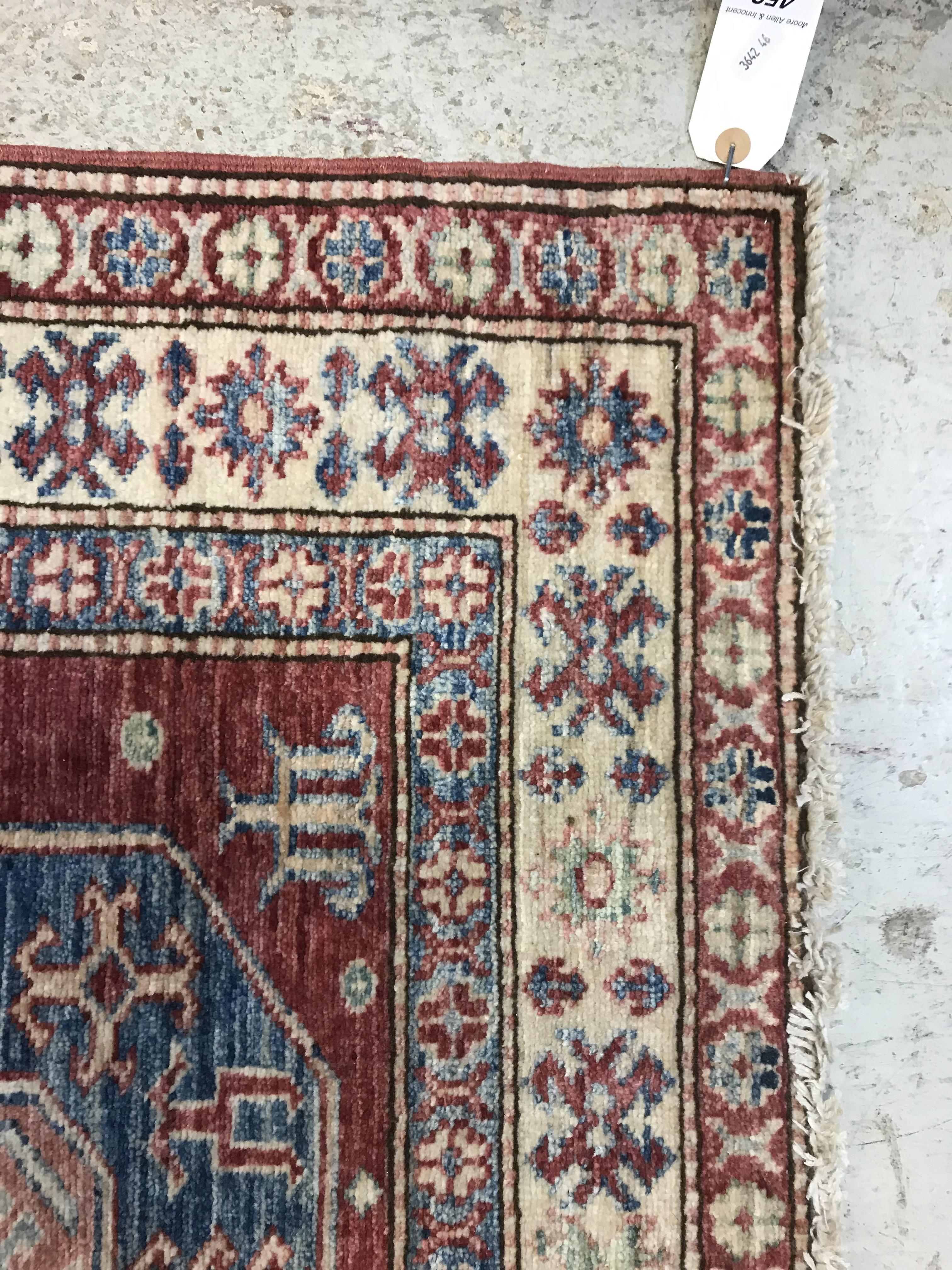 A modern Persian rug, the central panel set with three repeating medallions on a red ground, - Image 6 of 9