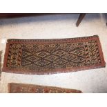 A Bokhara Torba rug, the central panel set with repeating lozenge medallions on a brown ground,