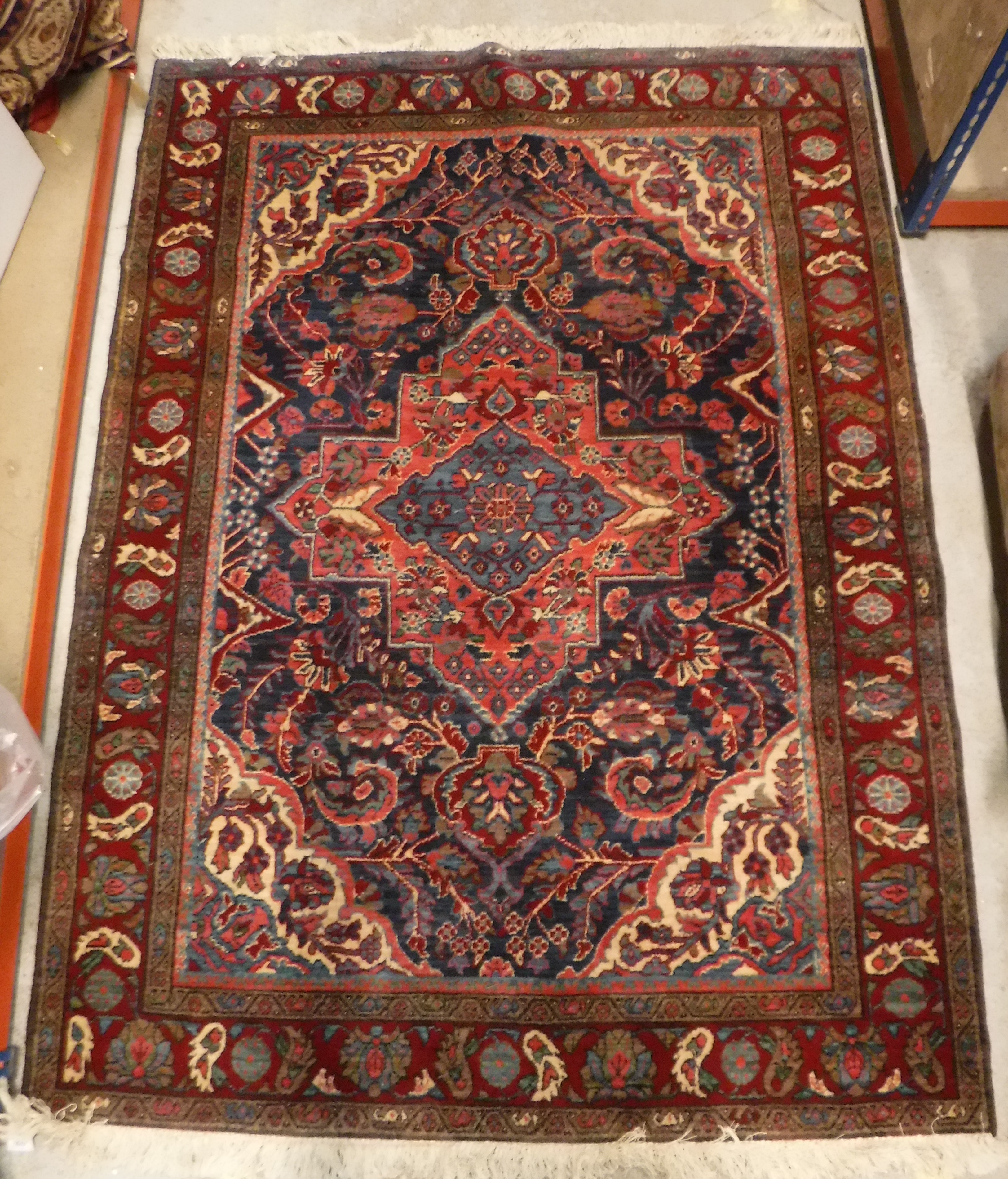 An Oriental carpet, the central panel set with foliate decorated medallion on a red and blue - Image 10 of 11