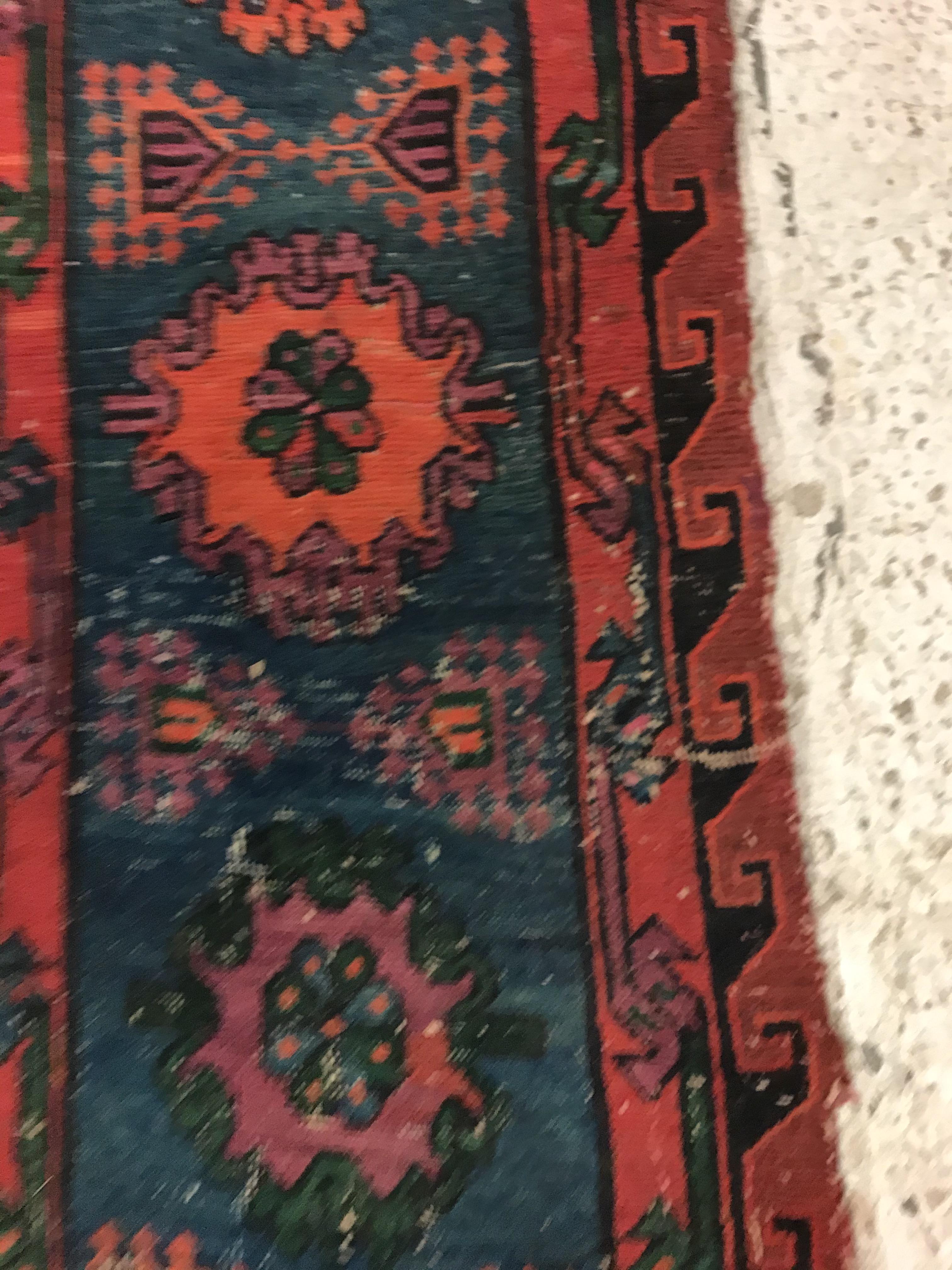 A Persian rug with three repeating lozenge medallions on a red and blue ground, within a blue, red - Image 18 of 20