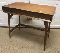 A West Elm teak mini desk, the plain top above a single frieze drawer on turned tapering splayed