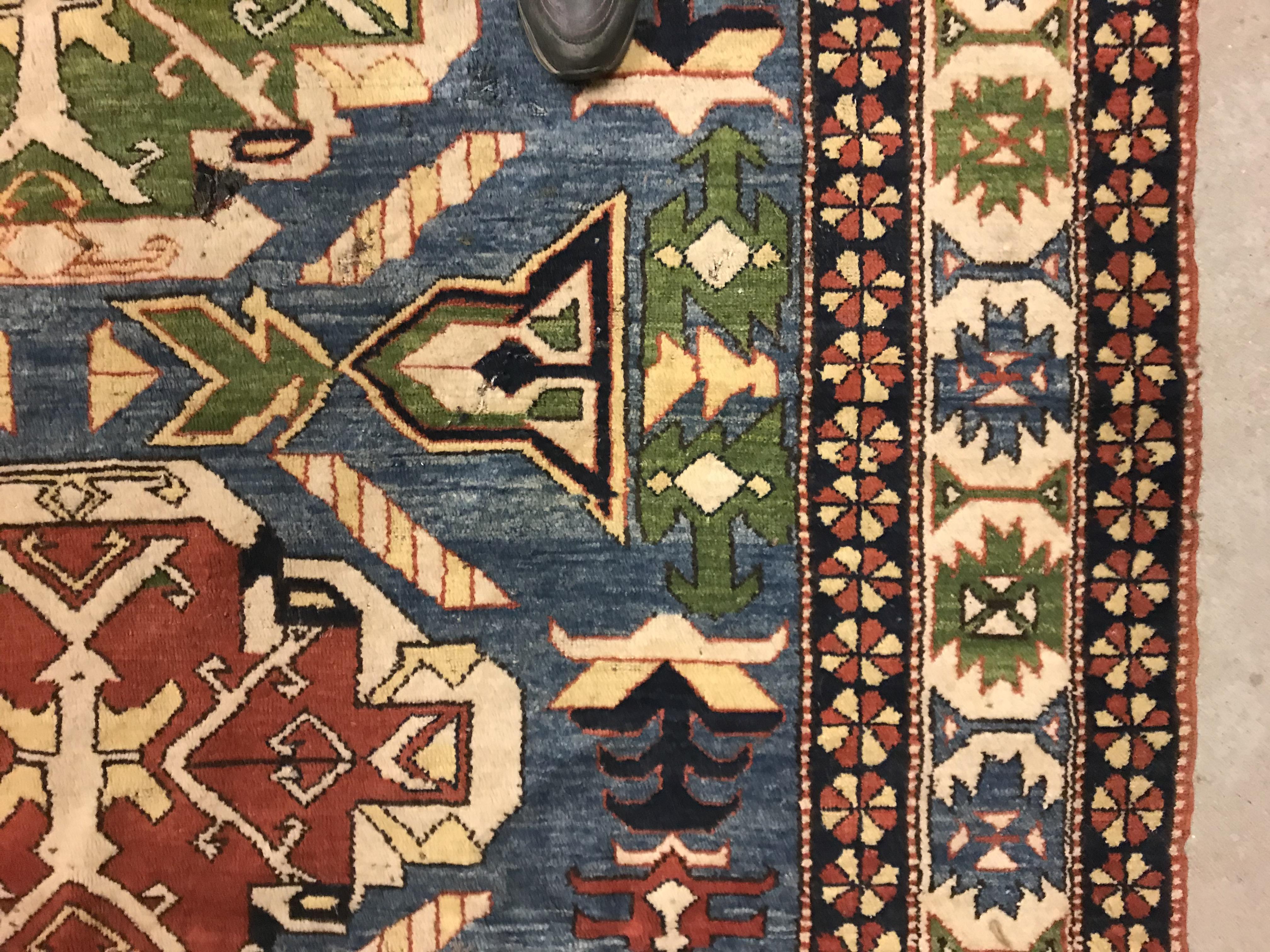 A Caucasian rug, the central panel set with three repeating medallions on a pale blue ground, within - Image 5 of 33