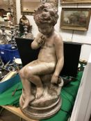 AFTER FALCONET 'Cupid' a young boy seated upon a rock with quiver of arrows and flower, patinated