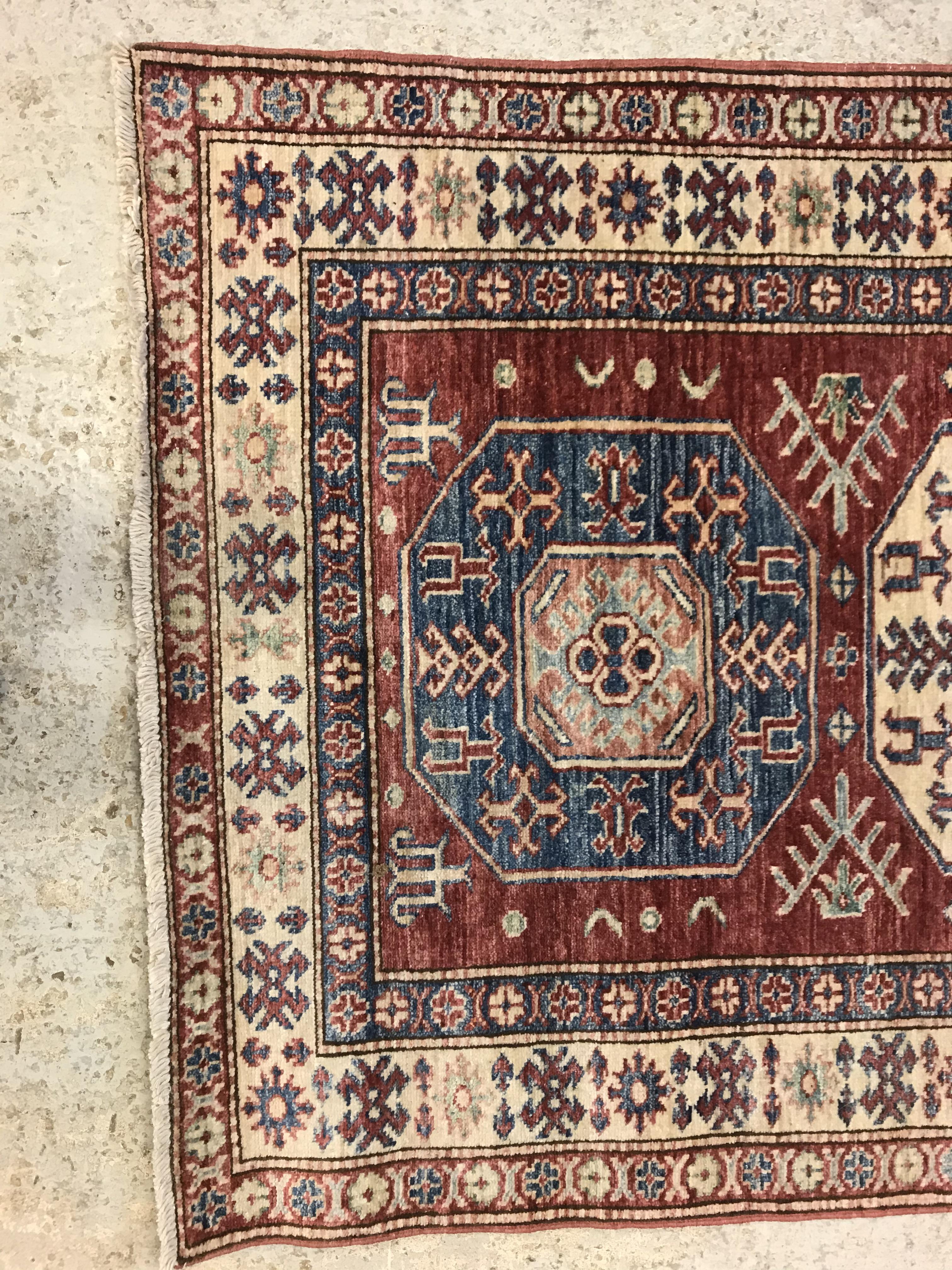 A modern Persian rug, the central panel set with three repeating medallions on a red ground, - Image 2 of 9