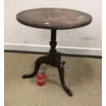 A 19th Century mahogany occasional table, the circular top on a vase turned and ringed centre