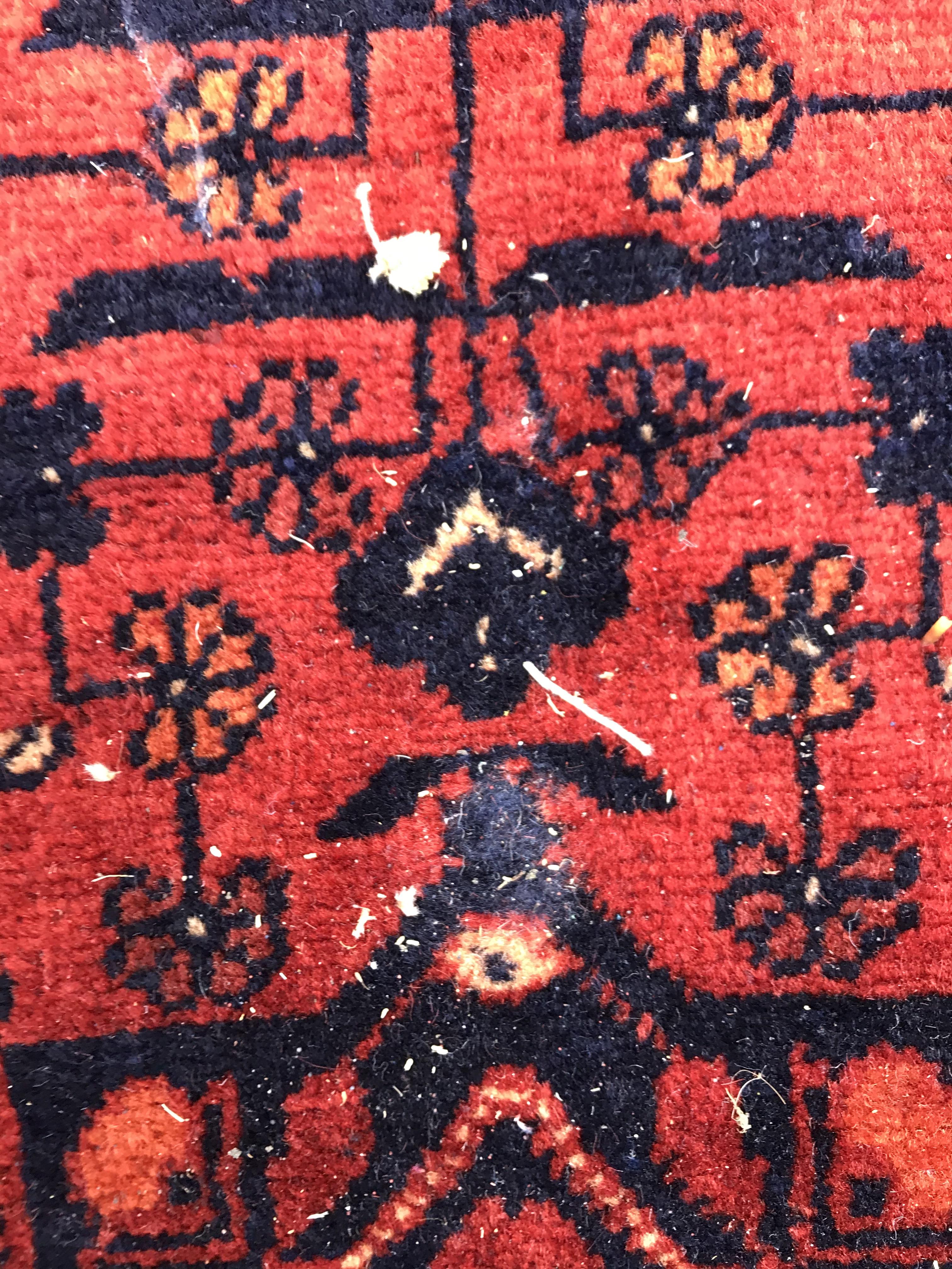 A Bokhara type carpet, the central panel set with repeating medallions on a dark red and black - Image 20 of 23