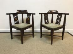 Two Edwardian mahogany and inlaid yoke back corner chairs of typical form