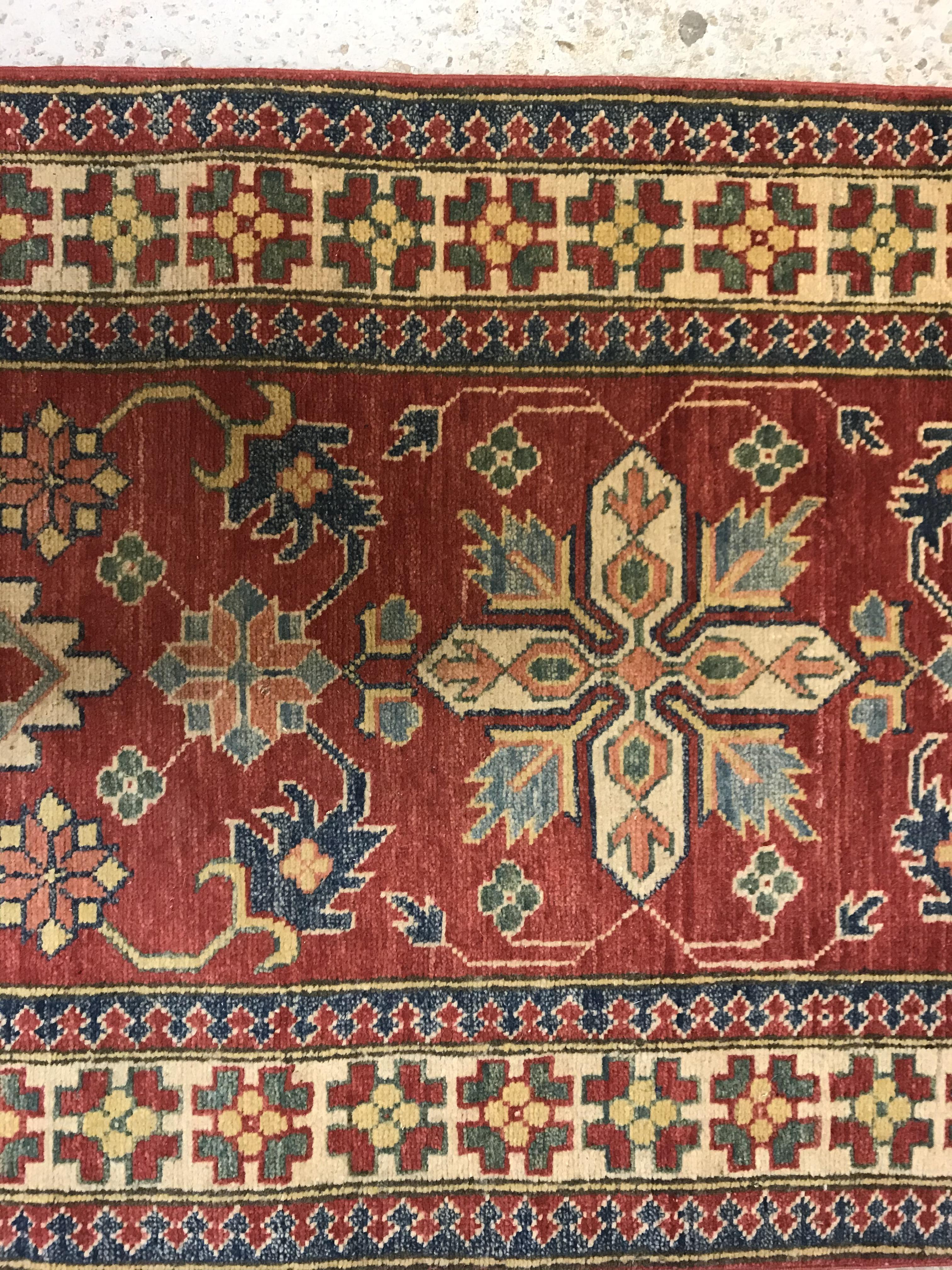 A modern Persian runner, the central panel set with repeating medallions on a red floral decorated - Image 4 of 13