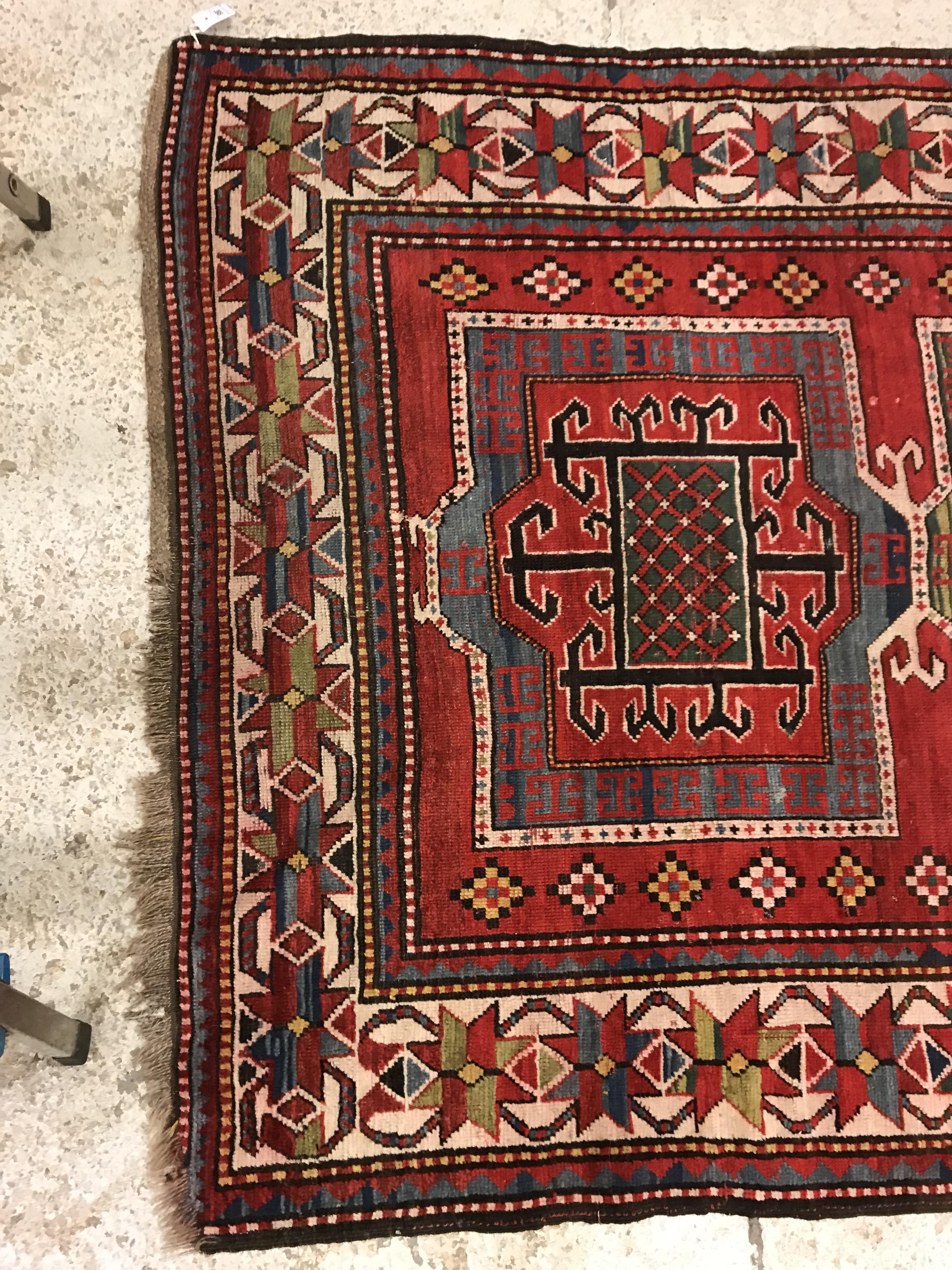 A Kasak runner, the central panel set with three repeating square medallions on a red ground - Image 2 of 10