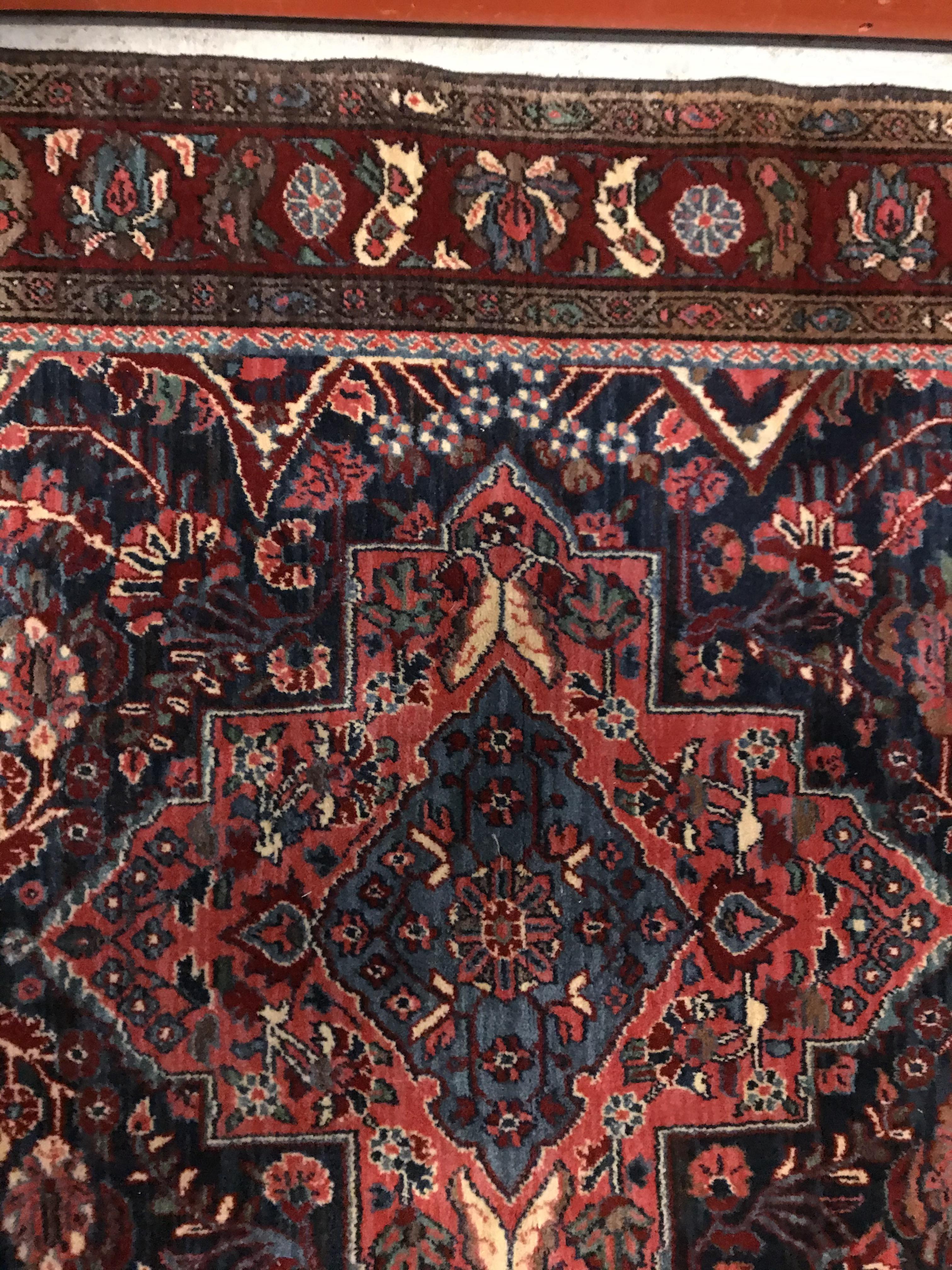 An Oriental carpet, the central panel set with foliate decorated medallion on a red and blue - Image 5 of 11