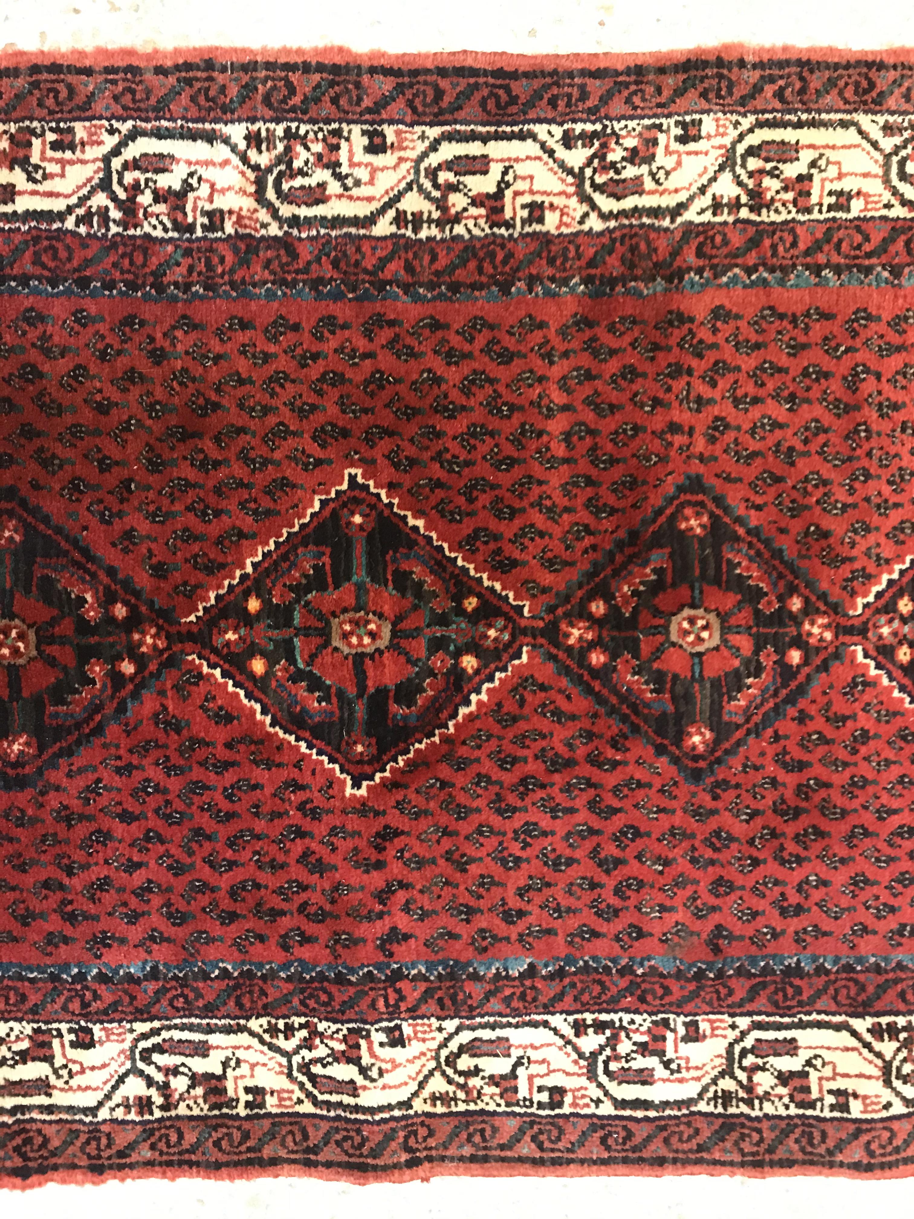 A modern Persian (Iran) runner, the red ground with repeating lozenge medallion with hook style - Image 9 of 23