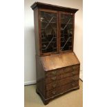 A George III mahogany bureau bookcase, the upper section with astragal glazed doors enclosing