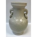 A Chinese cream glazed pottery vase with relief floral decoration to the baluster body and