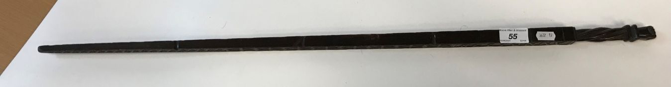 An 18th Century Continental carved treen ware tally stick with clenched fist finial over a rope-