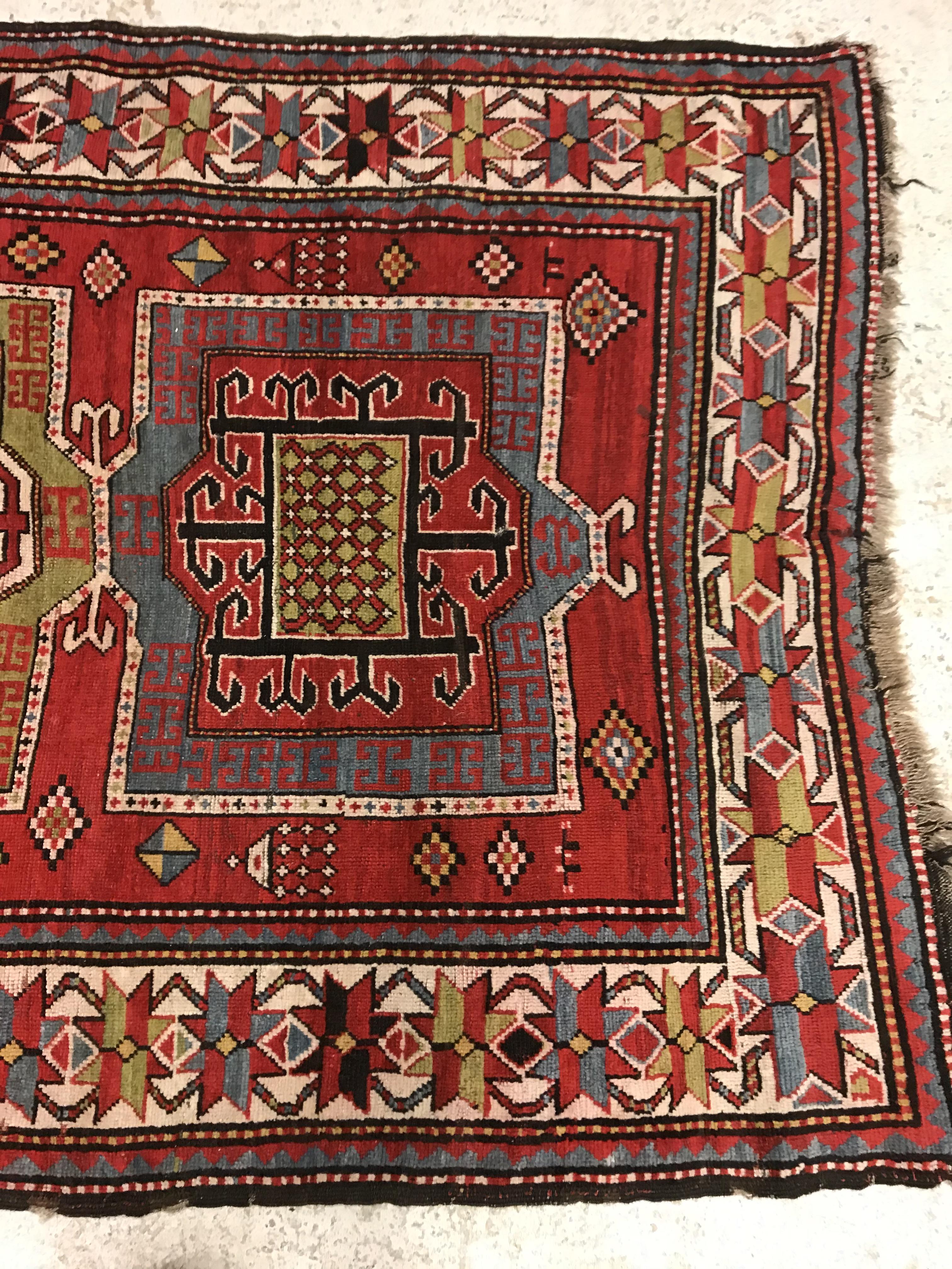 A Kasak runner, the central panel set with three repeating square medallions on a red ground - Image 4 of 10