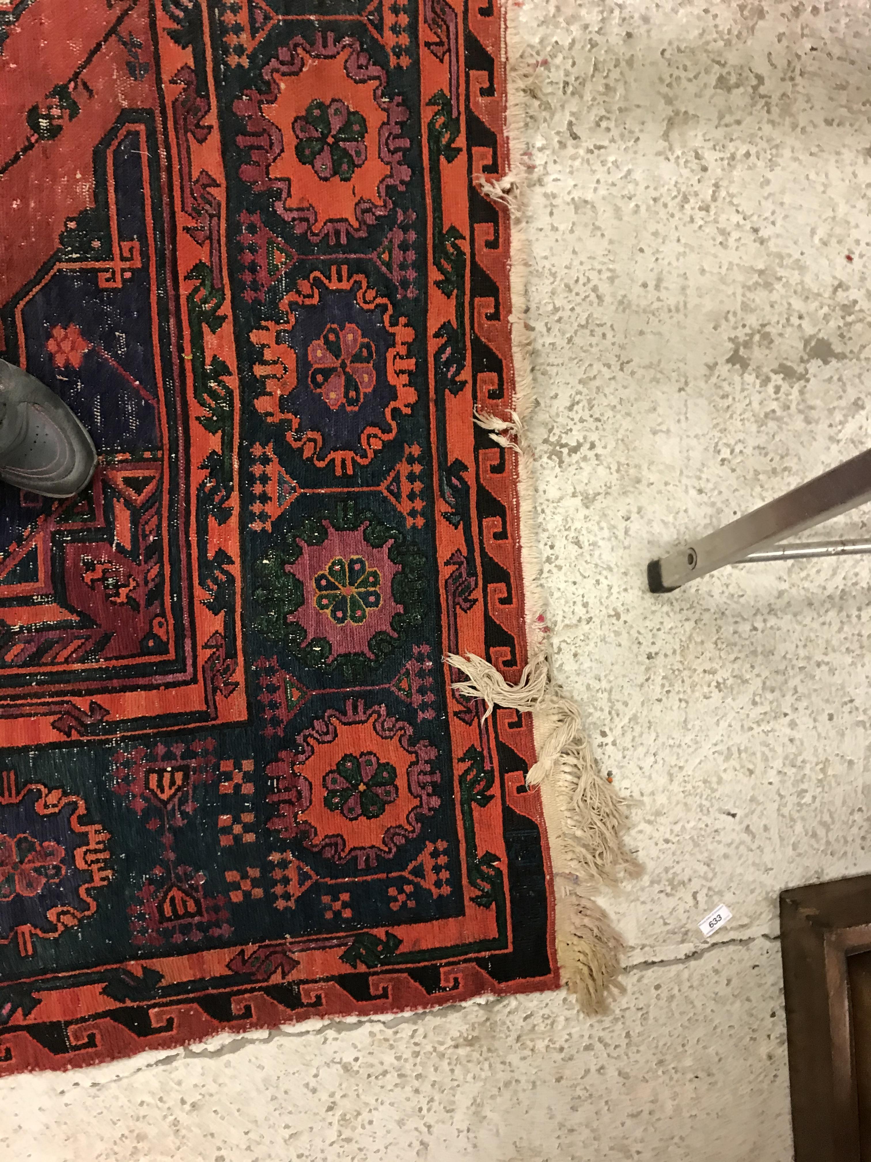 A Persian rug with three repeating lozenge medallions on a red and blue ground, within a blue, red - Image 17 of 20