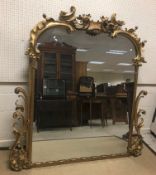 A Victorian giltwood and gesso framed overmantel mirror with scrolling foliate decoration, 169 cm