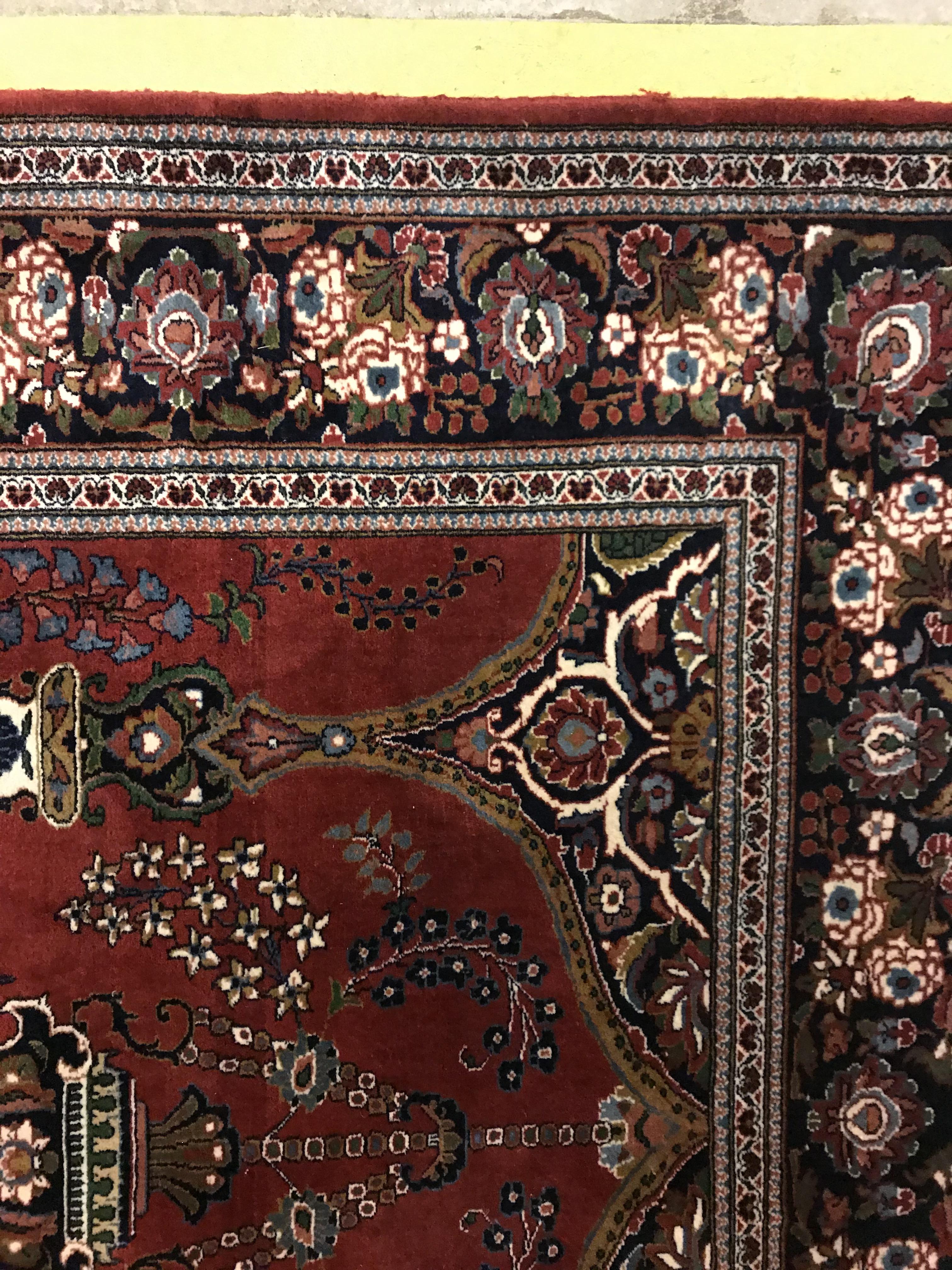 A Kashan prayer rug, the central panel set with Mirhab design with vase of flowers to base, on a red - Image 9 of 13