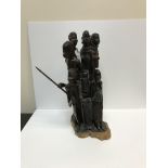 A 20th Century carved coromandel or king ebony Masai figure group depicting eight figures, some