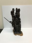 A 20th Century carved coromandel or king ebony Masai figure group depicting eight figures, some