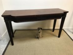 A late George III mahogany serving table, the plain top over a breakfront with fluted harebell