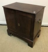 An 18th Century oak dwarf cupboard, the plain top with moulded edge over two panelled doors