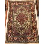A fine Isphahan rug, the central panel set with foliate decorated medallions on a red and cream