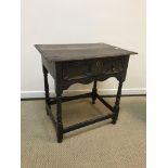 A 19th Century oak side table in the 17th Century manner, the plank top with moulded edge above a
