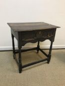 A 19th Century oak side table in the 17th Century manner, the plank top with moulded edge above a