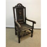 A 19th Century carved oak panel seated hall chair, 117 cm high