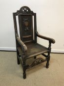 A 19th Century carved oak panel seated hall chair, 117 cm high